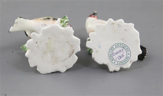 A near pair of Derby figures of goldfinches, c.1765-70, h. 6.3 and 6.5cm, one restored